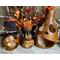 This shows three ghostly pumpkin gourds on a Halloween table display. There are three sizes, each with stitched scars on their faces.